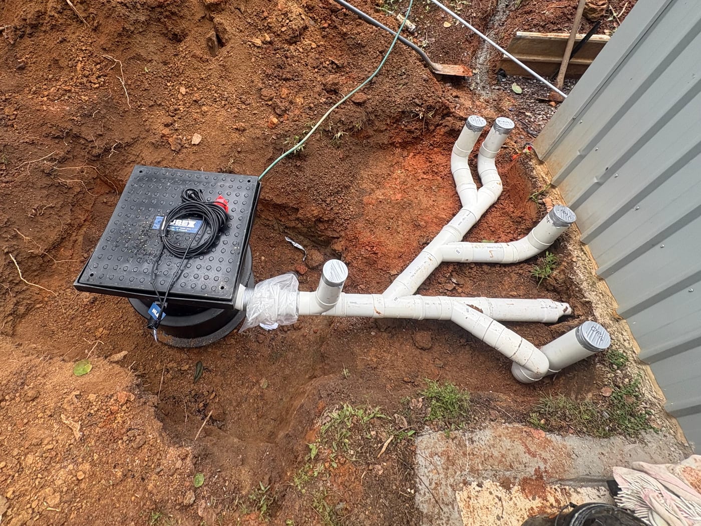 Sewer pump pit and new drainage junctions in an excavated trench