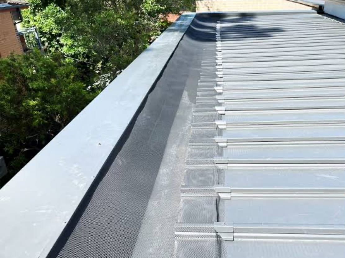 Box gutter with leaf mesh on a metal roof